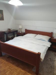 a bedroom with a large bed with two night tables at Terme Čatež Apartma Nine in Čatež ob Savi +34 photos