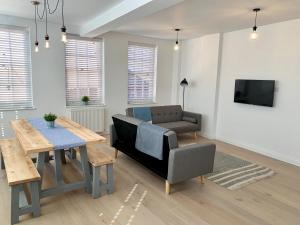 a living room with a couch and a table at 1 Central Chambers in Stratford-upon-Avon