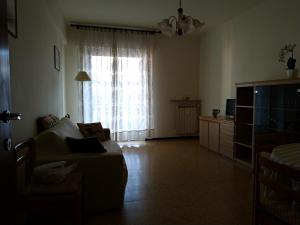 a living room with a couch and a window at Via della Chiusa 101 in Sestri Levante