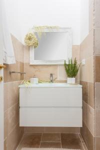 baño con lavabo blanco y ventana en Masseria Monache en San Pietro Vernotico