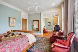 a bedroom with a bed and a living room at Maison Perrier Bed & Breakfast in New Orleans