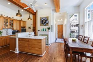 a kitchen with wooden cabinets and wooden floors at Maison Perrier Bed & Breakfast in New Orleans