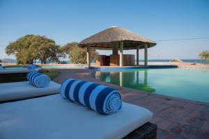 a resort with a pool and a gazebo at Kambiri Beach by Serendib in Senga