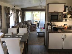 a kitchen and living room with a couch and a table at Logi-Bear Lodge with Hot Tub in Felton