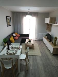ein Wohnzimmer mit einem Sofa und einem Tisch in der Unterkunft Cesar Augusto House in Saragossa
