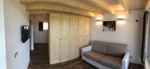 a living room with a couch and a large closet at Alice in Castello Tesino