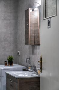 a bathroom with a sink and a toilet and a sink at Apartment at the foothills of Acropolis in Athens