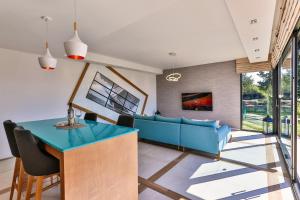 a living room with a blue couch and a table at Taihouse in Bar