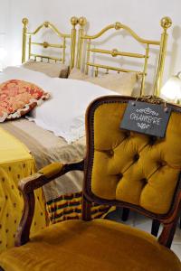 a bed and a chair with a sign on it at Il Toscano - near Grotta Giusti in Monsummano Terme