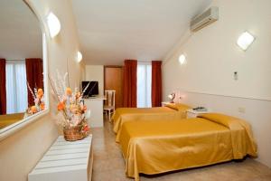 Postel nebo postele na pokoji v ubytování Hotel Massimino