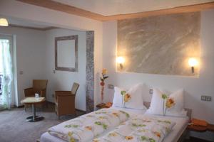 a bedroom with a large bed in a room at Hotel garni Milseburg in Hilders