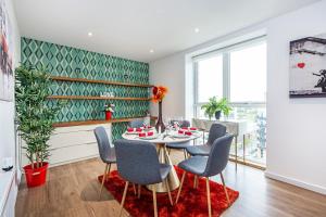 a dining room with a table and chairs at Chiswick Park Apartments London in London