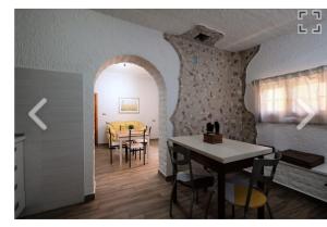 皮內托的住宿－BOUGANVILLE casa vacanza，厨房以及带桌椅的用餐室。