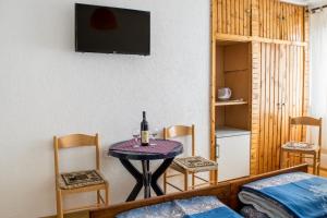 a room with a table with a bottle of wine on it at Golubović Apartments in Žabljak