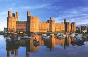 a large building with boats in a body of water at Ystumgwern Luxury Barn Conversions in Dyffryn