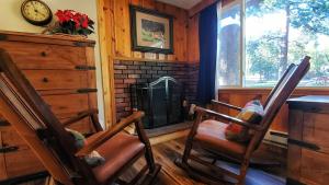 a living room filled with furniture and a fireplace at The Inn on Fall River & Fall River Cabins in Estes Park