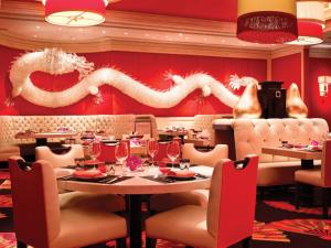 a dining room with a dragon on the wall at Encore at Wynn Las Vegas in Las Vegas