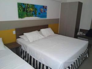 Una cama o camas en una habitación de Apartamento em Olímpia em frente ao Thermas 7 fotos más