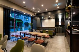 a restaurant with a table and chairs and a bar at Grids Tokyo Ueno Hotel&Hostel in Tokyo