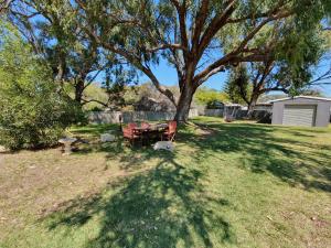 a picnic table under a tree in a yard at Just Chillin in Lancelin