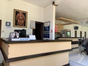 a cashier counter in a waiting room with a head on the wall at D'Mell Bali in Nusa Dua