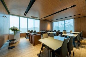a restaurant with tables and chairs and large windows at SureStay by Best Western Bangkok Ramintra in Bangkok