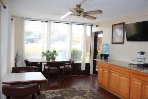 a living room with a dining room table with a ceiling fan at Economy Inn - Statesville in Statesville