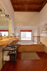 a bathroom with a large tub and a large sink at Pantheon Palazzo Nari in Rome