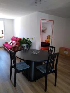 a living room with a table and chairs and a couch at La Garitinne in Onjon