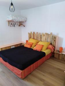 a bedroom with a bed with a wooden headboard at La Garitinne in Onjon