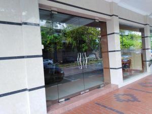 a store front with glass windows on a building at Sara Hotel in Labuan