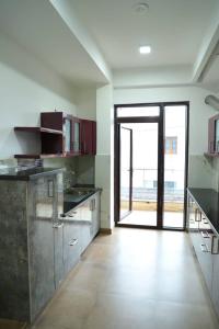 a large kitchen with an open door to a patio at Best Properties In Rishikesh in Rishīkesh