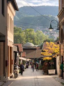 a group of people walking down a street at D&K apartments in Sarajevo