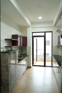 a large kitchen with an open door to a patio at The Most Beautiful Property Of Rishikesh in Rishīkesh