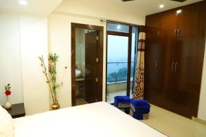 a bedroom with a bed and a sliding glass door at The Most Beautiful Property Of Rishikesh in Rishīkesh