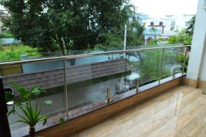 a balcony with a view of a garden at The Most Beautiful Property Of Rishikesh in Rishīkesh