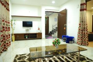 a living room with a glass table and a television at The Most Beautiful Property Of Rishikesh in Rishīkesh