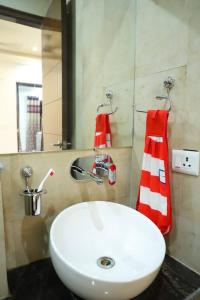 a bathroom with a white sink and a mirror at The Most Beautiful Property Of Rishikesh in Rishīkesh