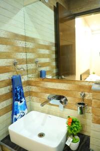 a white sink in a bathroom with a mirror at The Most Beautiful Property Of Rishikesh in Rishīkesh