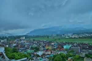 a cityscape of a city with mountains in the background at The Most Beautiful Property Of Rishikesh in Rishīkesh