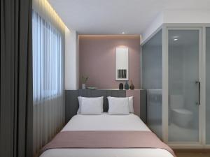 a bedroom with a large bed and a bathroom at Happy Dragon City Center Alley Hotel Forbidden City in Beijing