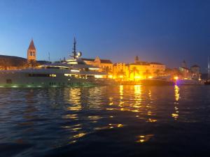 a large yacht is docked in a harbor at night at Apartment Marin in Trogir
