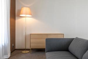 a living room with a couch and a lamp at yoin hotel kyoto gion in Kyoto