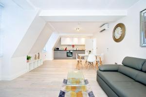 a living room with a couch and a table at Eldon Chambers Flat 2 by City Living London in London