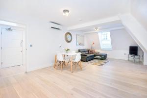 a living room with a table and a couch at Eldon Chambers Flat 2 by City Living London in London