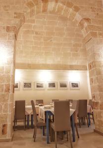 a dining room with a long table and chairs at Antica Masseria Torre Mozza in Torre Santa Susanna