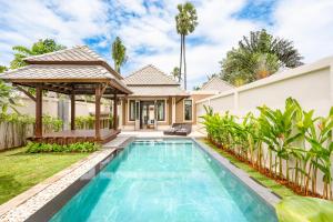 a villa with a swimming pool and a gazebo at Fair House Villas & Spa, Koh Samui in Mae Nam