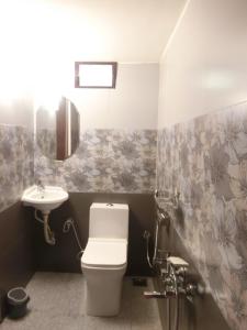 a bathroom with a toilet and a sink at Kochill - Relax & Stay - in Cochin