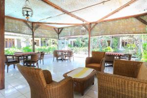 an outdoor patio with tables and chairs and tables at Sari Bali Resort in Kuta