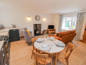 a kitchen and living room with a table and chairs at Cherry Cottage in Whitby